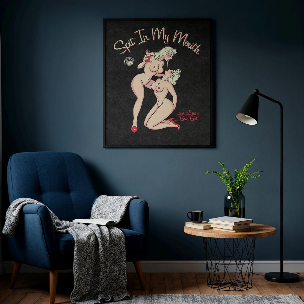 a cozy living room with a blue armchair, a wooden coffee table, and a framed poster on the wall. The poster depicts two naked women and includes the text "Spit In My Mouth" and "and all I want is a Good Old Club".