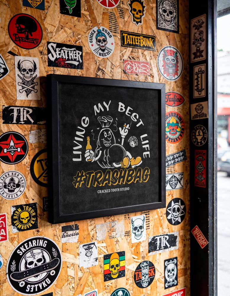 a wall covered in various stickers, posters, and graffiti, creating a visually busy and eclectic display.
