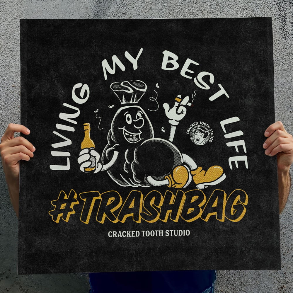 A person is holding up a black poster with a cartoon character and text.
