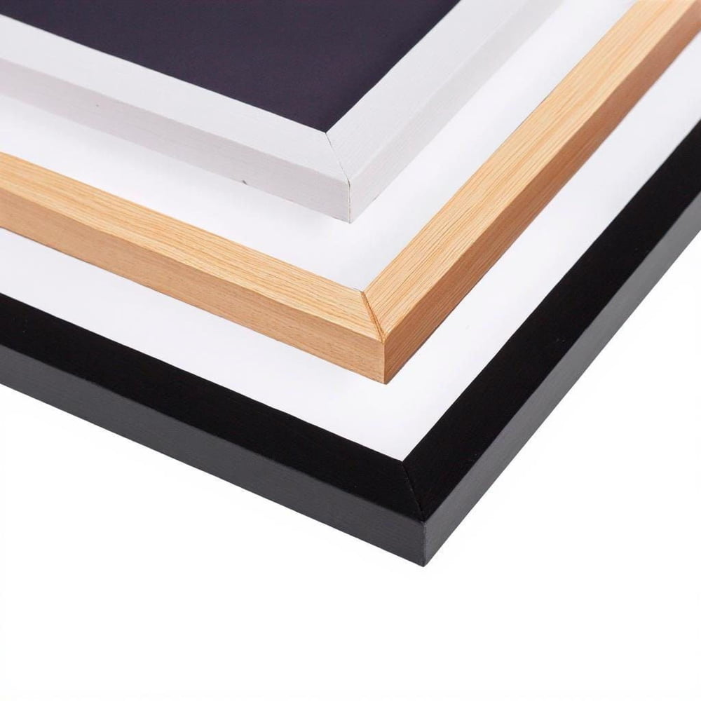 a close-up view of a stack of four different colored picture frames, including black, white, and wooden frames.