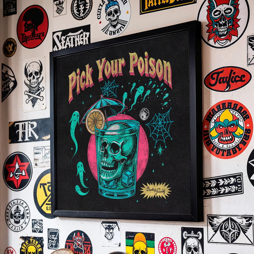 a framed poster with a skull and a cocktail glass, surrounded by various stickers and decals on a wall.