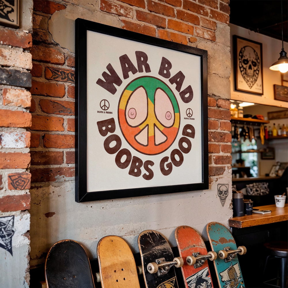 a framed poster with the text "WAR BAD BOBS GOOD" and a peace sign, hanging on a brick wall. Below the poster, there are several skateboards lined up against the wall.