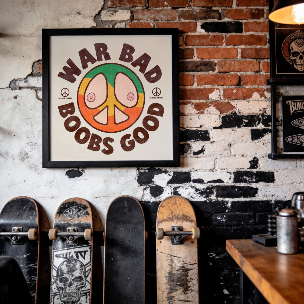 a framed poster with the text "WAR BAD BOYS GOOD" and a peace symbol, hanging on a brick wall. Below the poster, there are several skateboards lined up against the wall.
