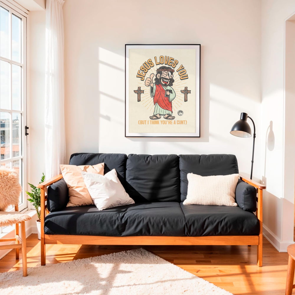 A black futon sofa with a framed poster of a cartoon character above it, in a bright and airy living room with a large window and a lamp.