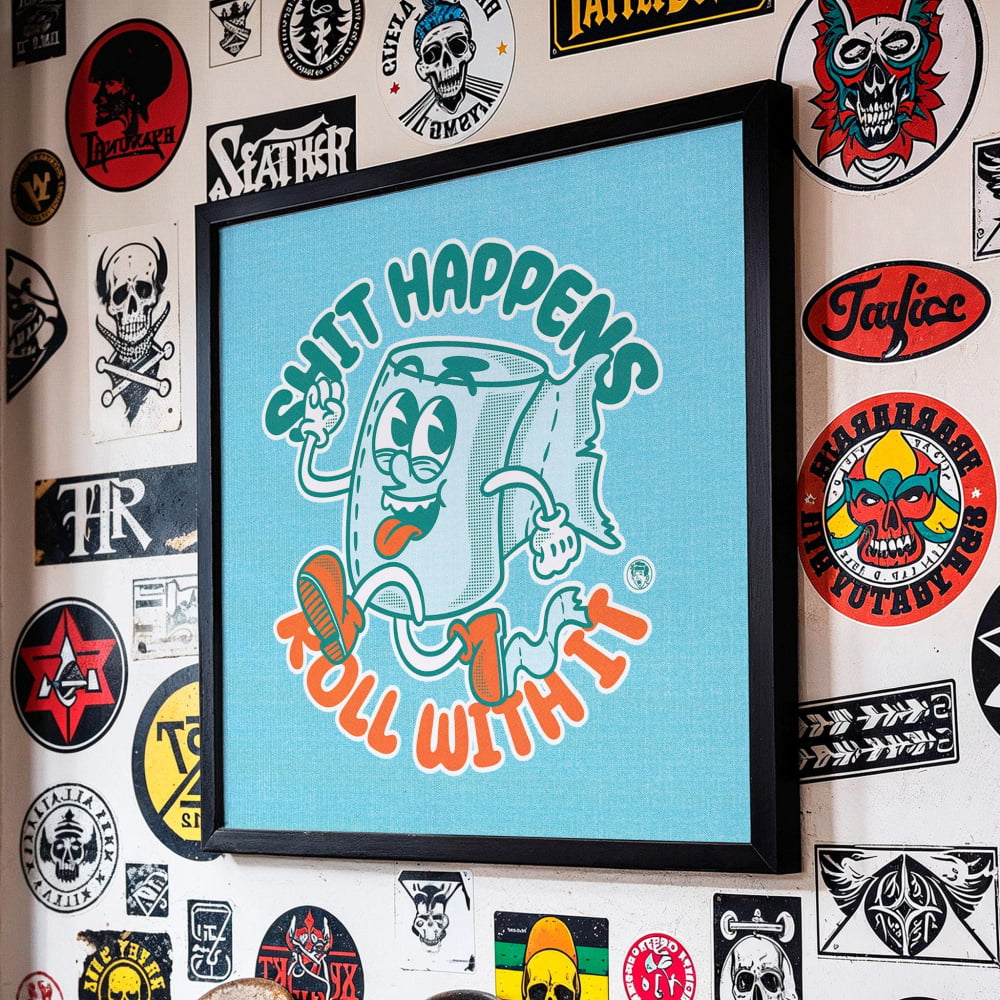a wall adorned with a variety of stickers, patches, and graffiti, including a prominent framed graphic with the text "SHIT HAPPENS ROLL WITH IT".