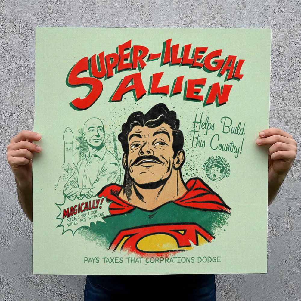 a person holding up a poster with a comic-style illustration of a man wearing a superhero costume. The poster has a humorous and exaggerated title that reads "Super-Illegal Alien" and includes a speech bubble saying "MAGICALLY! STEAL YOUR JOB WHILE NOT HELD BY THE CORPORPATRIOT!" The poster also includes a statement about how the "PAYS TAXES THAT CORPORATIONS DODGE".