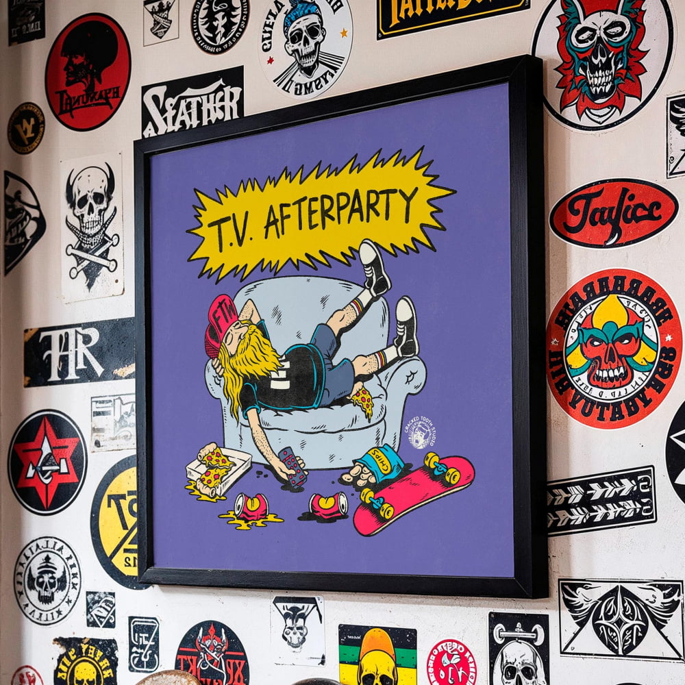 a framed poster with a cartoon illustration of a person lying on a couch with a skateboard and various objects around them, such as a pizza and a beer bottle.