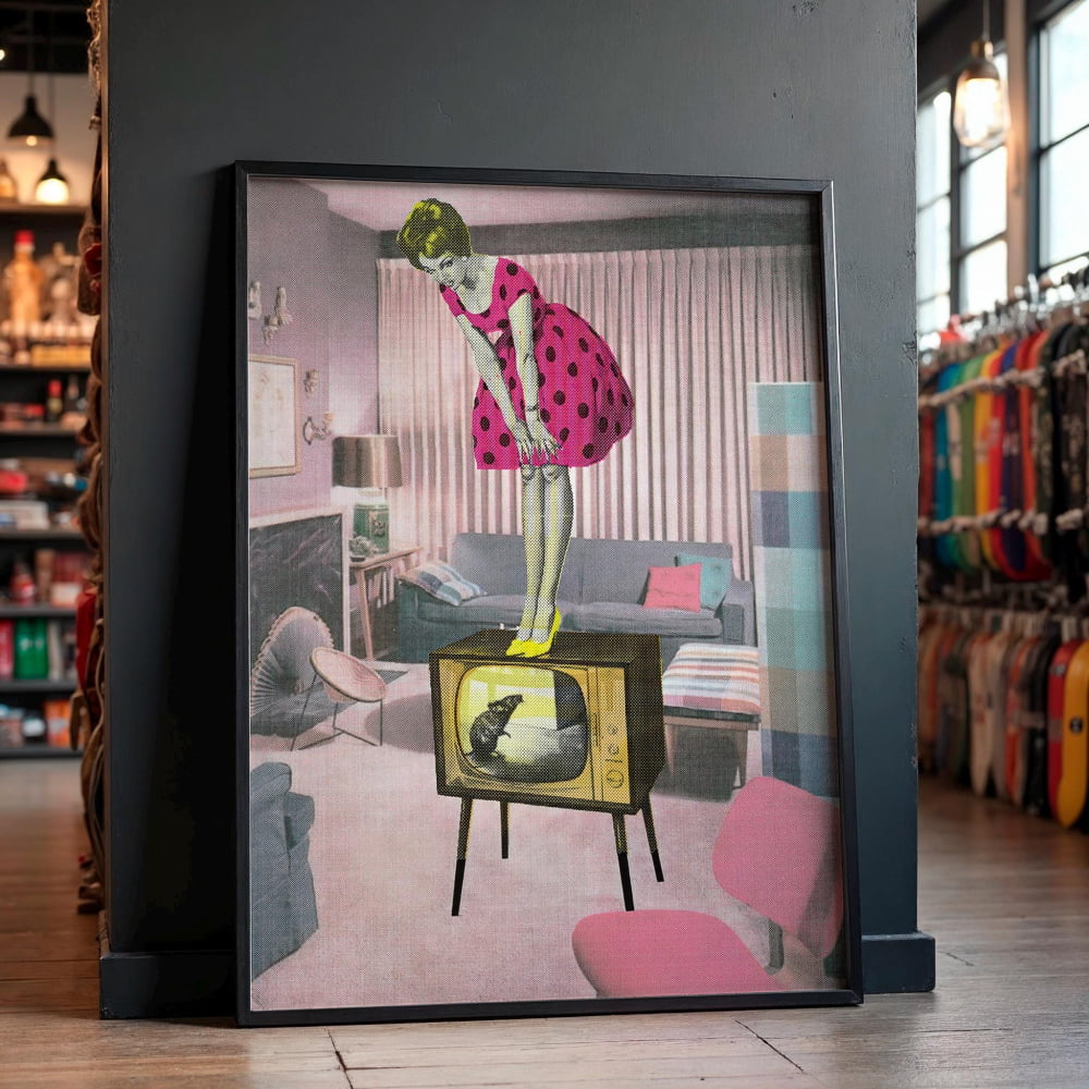 A framed collage depicting a woman in a pink polka dot dress standing on a television set, with a cat on the screen.