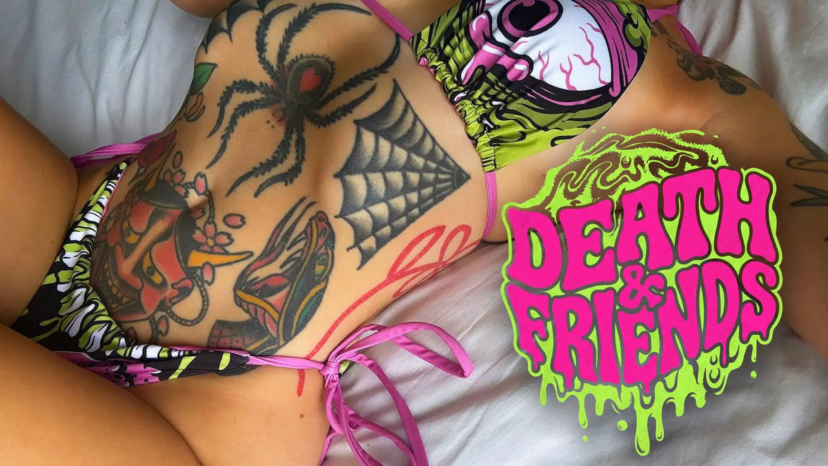 The bikini top features a vibrant, cartoonish eyeball design in pink and green with black outlines.