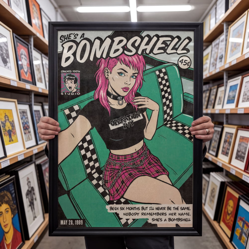 A person is holding up a framed poster featuring a pink-haired woman in a black and white checkered outfit, with a green and white checkered chair in the background.